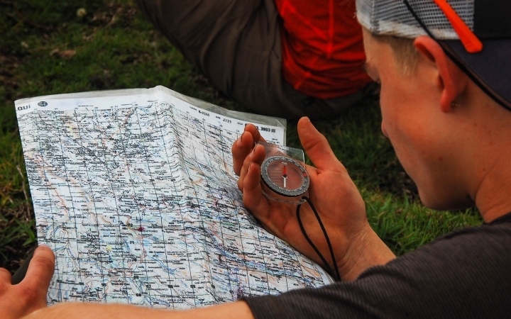 a student uses a compass and map on an outward bound gap year expedition
